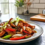 photorealistic black pepper chicken plated with glossy sauce and fresh garnish in modern kitchen