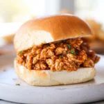 Cajun Chicken Sloppy Joes served on a toasted brioche bun in a modern kitchen