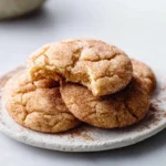 close-up of irresistibly chewy snickerdoodle cookies stacked on modern plate with cinnamon sugar coating