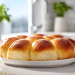 Soft, buttery Japanese Milk Bread Dinner Rolls freshly baked and plated in a modern kitchen with natural light.
