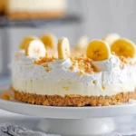 creamy no-bake banana pudding cheesecake on marble counter in natural light