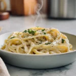 one pot creamy garlic pasta served in a bowl with parsley garnish on a modern kitchen counter