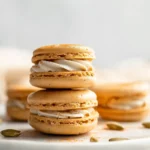 Pumpkin pie macarons on white plate in bright kitchen with natural light