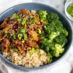 Chef Taha Ayad's Recipe Slow Cooker Honey Garlic Chicken served over rice with broccoli on a white platter