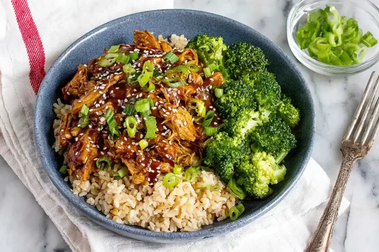 Chef Taha Ayad's Recipe Slow Cooker Honey Garlic Chicken served over rice with broccoli on a white platter