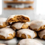 soft pumpkin cookies with cinnamon frosting on plate in modern kitchen with natural light