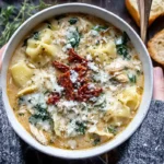 Chef Taha Ayad's Recipe White Lasagna Soup in a shallow bowl with spinach, mushrooms, noodles, and crispy prosciutto
