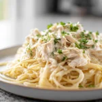 photorealistic hero shot of Crock Pot Angel Chicken served over pasta