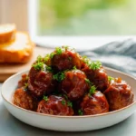 Crock Pot BBQ Meatballs plated with BBQ sauce and fresh garnish