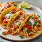 hero image of crockpot chicken tacos on a modern plate with natural lighting