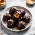 finished no-bake Butterfinger bites with chocolate coating on modern kitchen counter