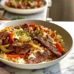 Finished Philly Cheesesteak Bowls served with steak, melted cheese, and peppers on rice