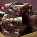 photorealistic hero image of slutty brownies cookie dough stacked on a plate