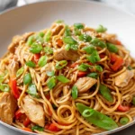 Photorealistic Chicken Lo Mein on modern plate with fresh vegetables and garnishes