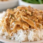 Crockpot Chicken and Gravy served over rice with thick savory gravy