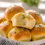 freshly baked garlic butter bread rolls on plate in modern kitchen