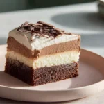 Slice of Italian Love Cake ready to serve on a modern plate