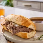 Slow Cooker French Dip sandwich with au jus on modern plate