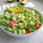 Fresh Green Goddess Salad with creamy green dressing in a white bowl