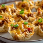 Taco Ranch Bites served warm on a plate with melted cheese and crisp phyllo shells