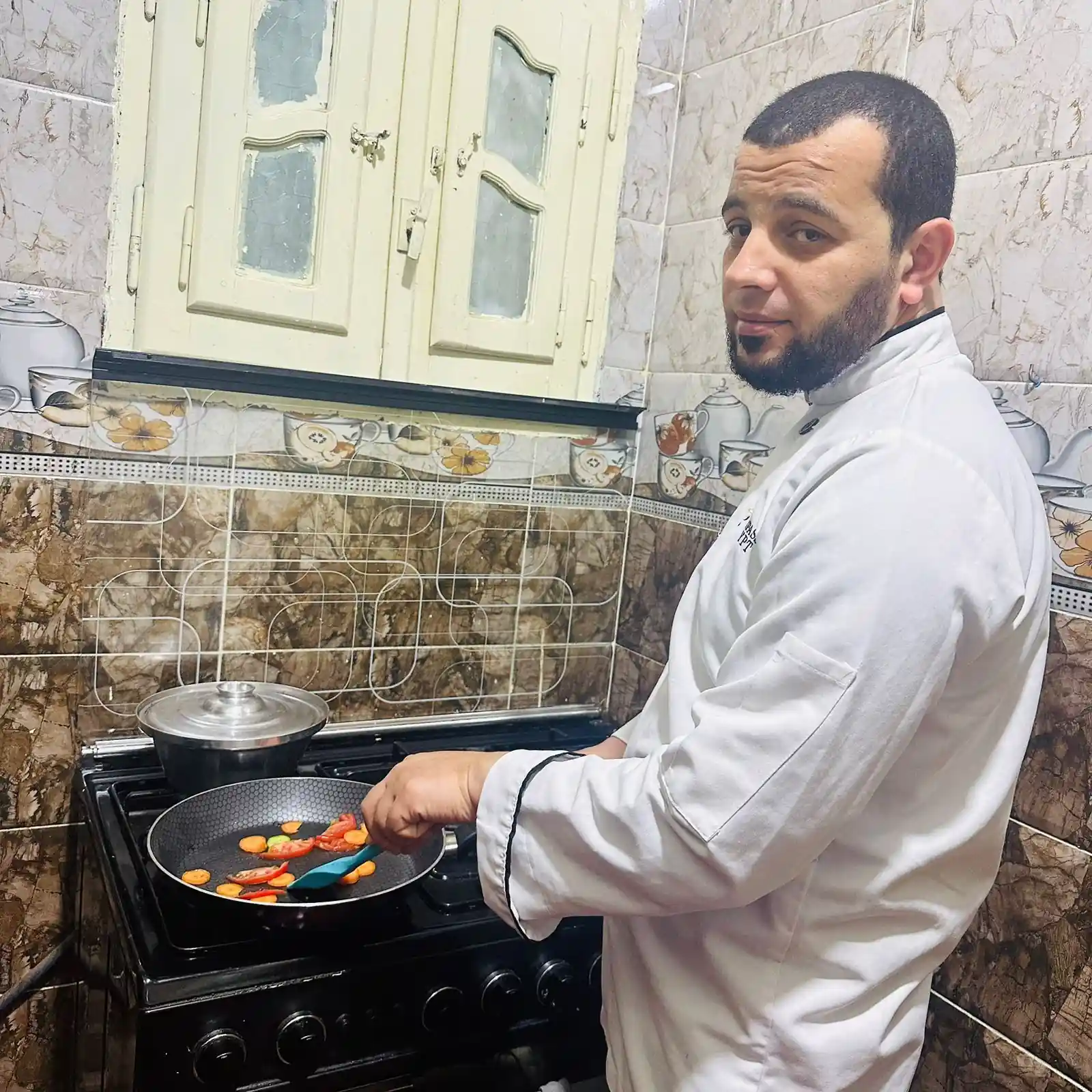 About 1 Chef Taha Ayad cooking fresh vegetables in his kitchen, founder of Daily Savory Recipes