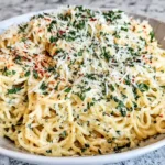 bowl of Creamy Garlic Pasta with parmesan and parsley in a bright home kitchen
