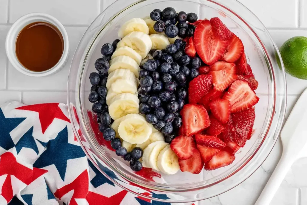 4th of July Fruit Salad With Honey Lime Dressing 12 4th of July fruit salad fruit combined in a glass bowl before dressing