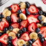 4th of July fruit salad recipe with strawberries blueberries bananas and honey lime dressing