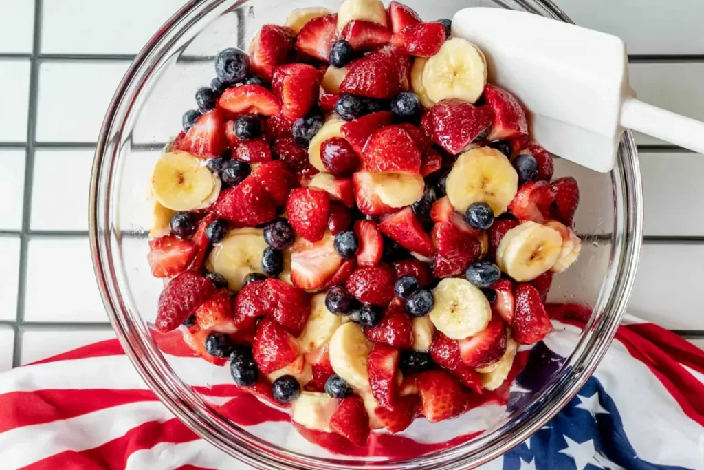 4th of July Fruit Salad With Honey Lime Dressing 14 4th of July fruit salad tossed with honey lime dressing in a bowl