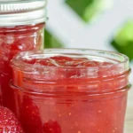 Strawberry Mango Jam recipe with jars of red fruit jam, fresh mango, and strawberries