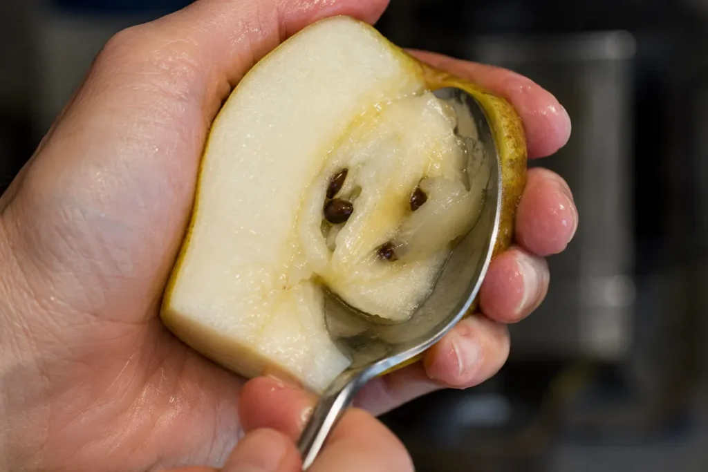 Cored pear half prepared for Baked Pears before baking