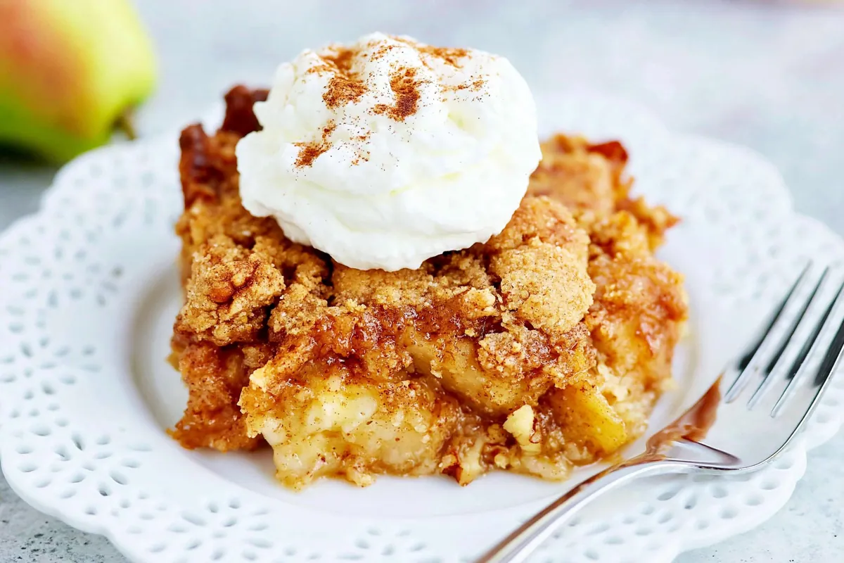 Chef Taha Ayad's Recipe Crumble Topping on a warm fruit dessert with cream
