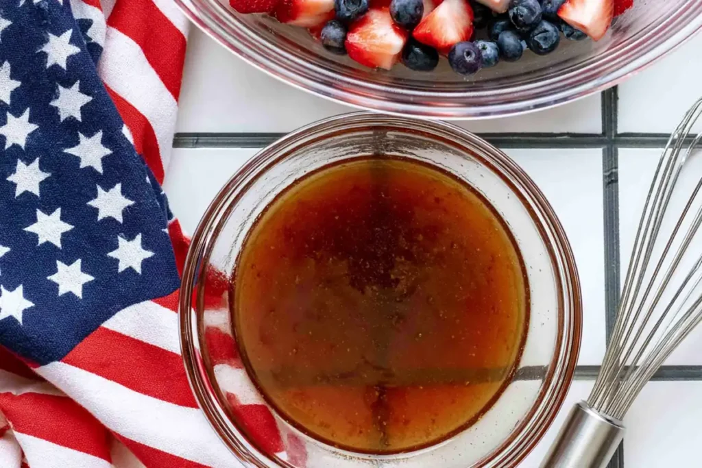 4th of July Fruit Salad With Honey Lime Dressing 13 Honey lime dressing for 4th of July fruit salad in a small bowl