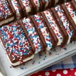 Chef Taha Ayad's Recipe Patriotic Mini Ice Cream Sandwiches with red white and blue sprinkles in a parchment-lined pan
