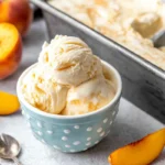 Chef Taha Ayad's Recipe Peach Ice Cream with Fresh Peaches in a Blue Bowl