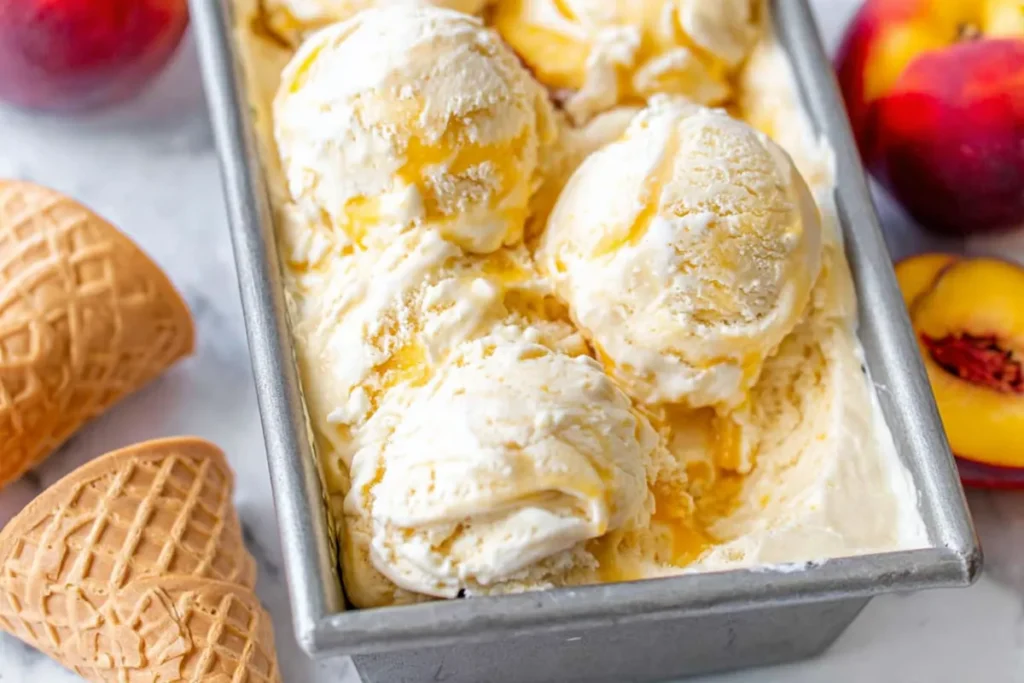 Peach Ice Cream with Fresh Summer Peaches and Classic Custard Base 26 Peach Ice Cream Frozen in a Loaf Pan with Waffle Cones and Peaches