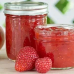 Chef Taha Ayad's Recipe Strawberry Mango Jam in stacked jars with fresh mango and strawberries