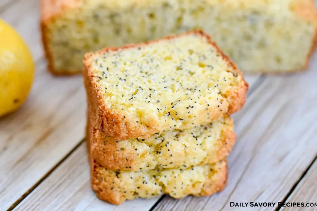 Stacked slices of Lemon Poppy Seed Zucchini Bread with visible zucchini flecks