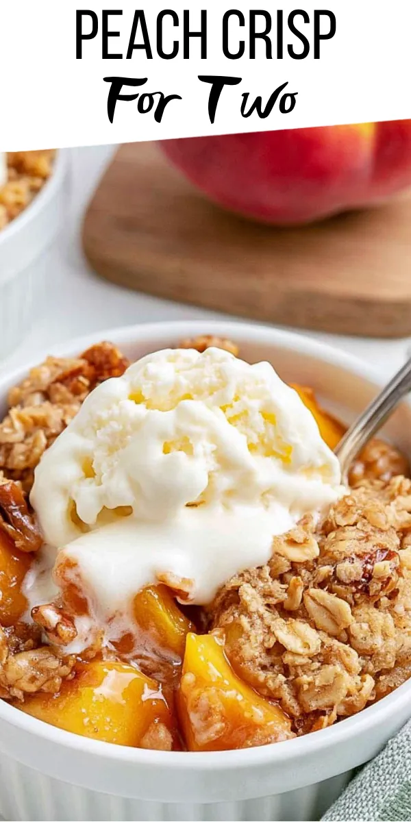 Peach Crisp for Two recipe served warm with oat crumble and vanilla ice cream