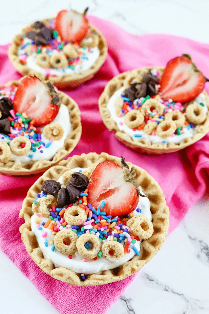 Yogurt Sundae Bowls with Strawberries and Crunchy Toppings 2 Colorful Yogurt Sundae Bowls with Strawberries and Crunchy Breakfast Toppings