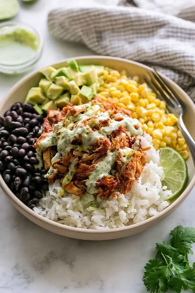 Slow Cooker Chicken Burrito Bowl for an Easy Family Dinner 2 Slow Cooker Chicken Burrito Bowl with tender chicken, rice, black beans, corn, avocado, cilantro, and lime