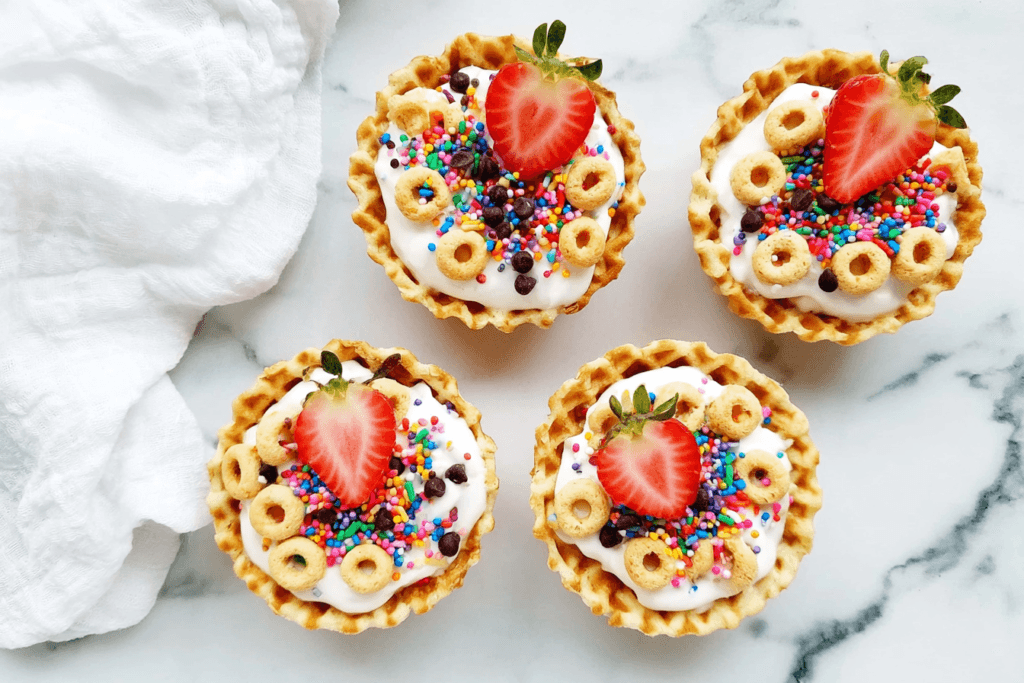 Yogurt Sundae Bowls with Strawberries and Crunchy Toppings 7 Finished Yogurt Sundae Bowls with Strawberries, Cheerios, Chocolate Chips, and Sprinkles