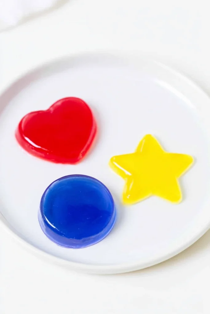 Jello Jigglers: A Firm, Colorful Finger Snack for Parties 3 Firm Jello Jigglers shaped as red hearts, a blue circle, and a yellow star