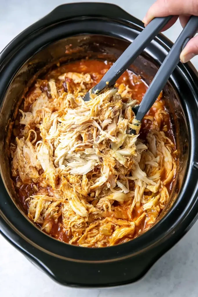 Slow Cooker Chicken Burrito Bowl for an Easy Family Dinner 4 Tender shredded Mexican chicken in a slow cooker for Slow Cooker Chicken Burrito Bowls