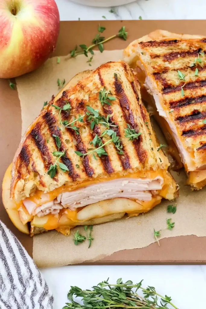 Turkey Apple Cheddar Panini ingredients layered with roasted turkey, Honeycrisp apple, sharp cheddar, and honey mustard